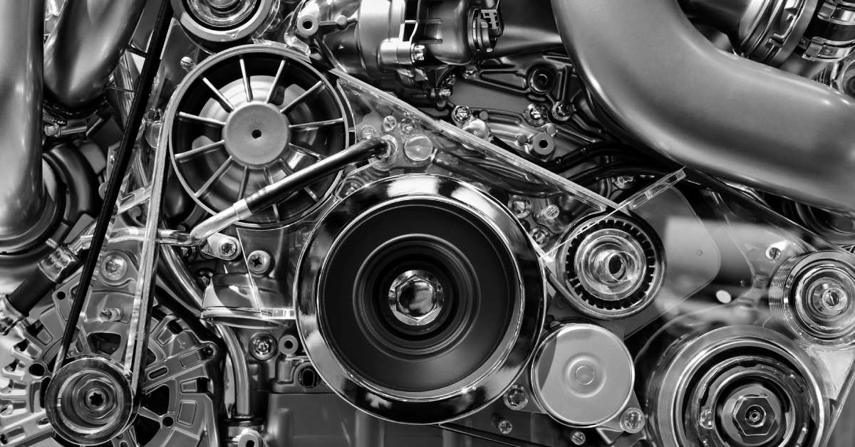 A close up of the inside of an engine. The various metal, chrome, and plastic components of the engine are visible.